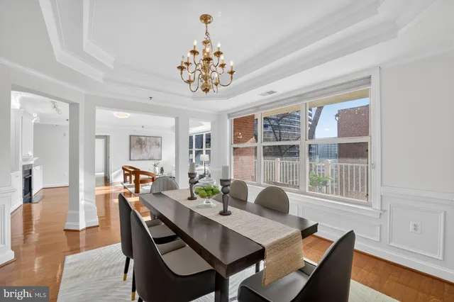 a view of a dining room with furniture wooden floor and chandelier