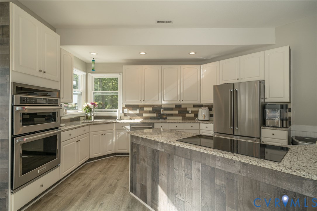12700 Coalboro Road Chesterfield, VA 23838 - Photo 12 of 50 Kitchen featuring white cabinetry, light-toned woo