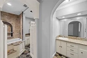 a spacious bathroom with a granite countertop sink and a mirror
