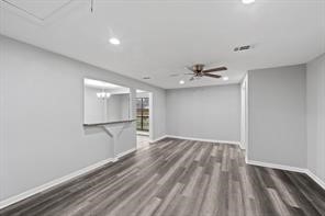 1227 Fair Drive Angleton, TX 77515 - Photo 12 of 18 a view of empty room with wooden floor and fan