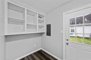 a view of small space with wooden floor and windows