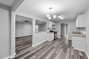 a view of a kitchen with microwave and cabinets