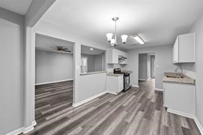 1227 Fair Drive Angleton, TX 77515 - Photo 7 of 18 a view of a kitchen with microwave and cabinets