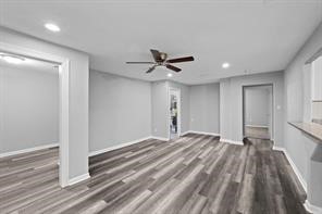 1227 Fair Drive Angleton, TX 77515 - Photo 8 of 18 a view of empty room with wooden floor and ceiling fan