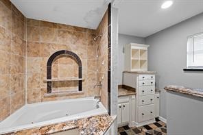 1227 Fair Drive Angleton, TX 77515 - Photo 10 of 18 a bathroom with a bathtub sink and mirror