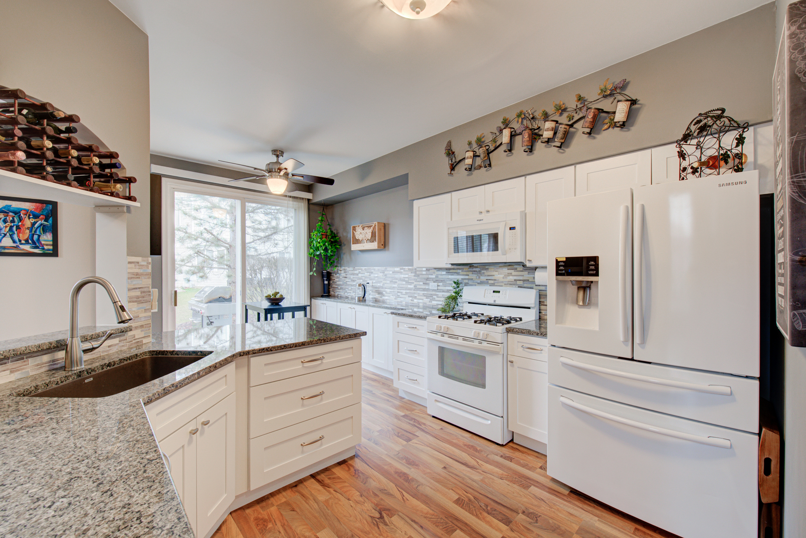 1201 Delta Drive Elgin, IL 60123 - Photo 11 of 42 a kitchen with granite countertop white cabinets white appliances and sink