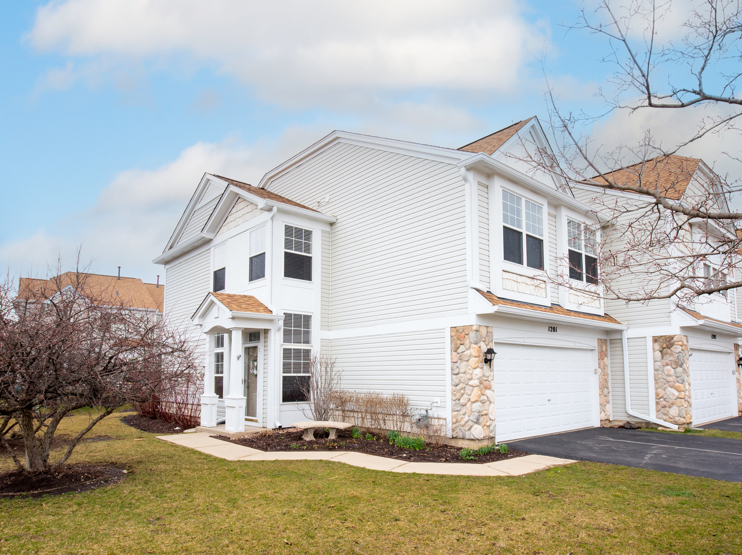 1201 Delta Drive Elgin, IL 60123 - Photo 3 of 42 a view of a white house with large windows and a small yard