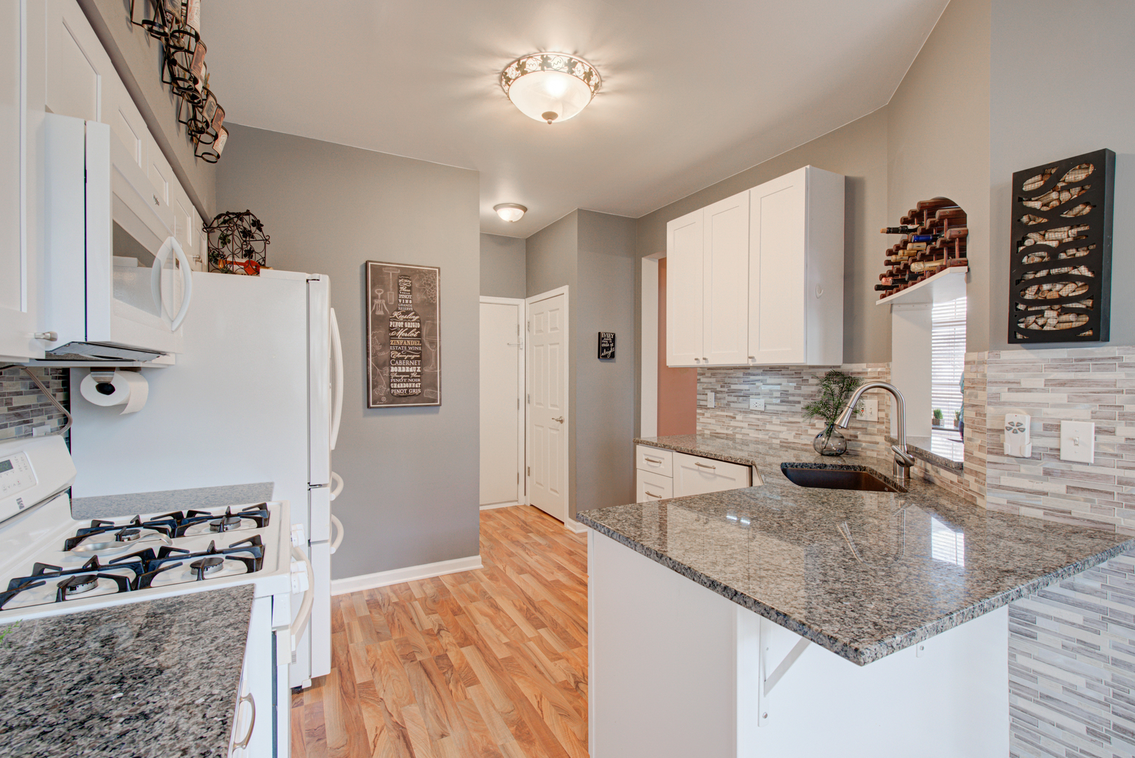 1201 Delta Drive Elgin, IL 60123 - Photo 9 of 42 a kitchen with granite countertop a sink stove and refrigerator