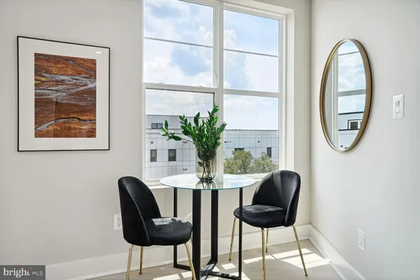 a dining room with furniture and a potted plant