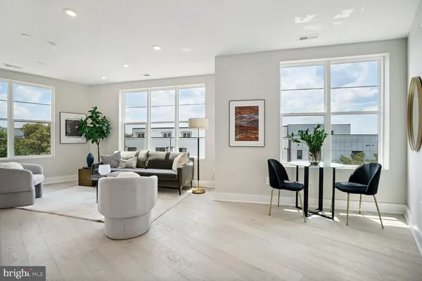 a living room with fireplace furniture and a large window