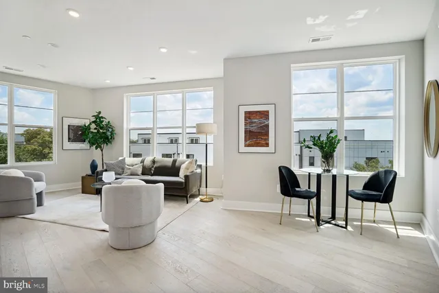 a living room with fireplace furniture and a large window
