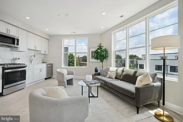a living room with furniture and a large window