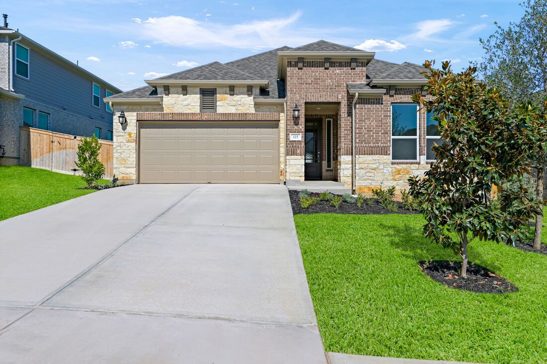 a front view of a house with a yard and garage