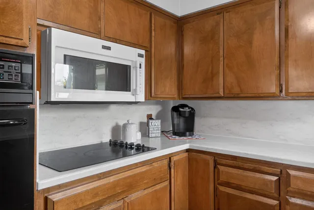 a living room with furniture a fireplace and a table