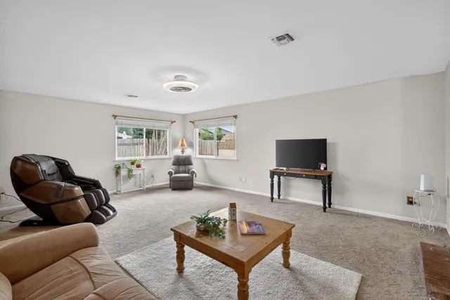 a bathroom with a granite countertop sink vanity mirror and toilet