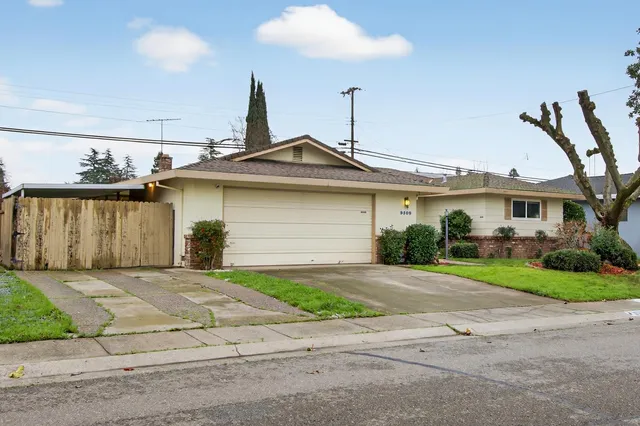 a front view of a house with a garden and patio