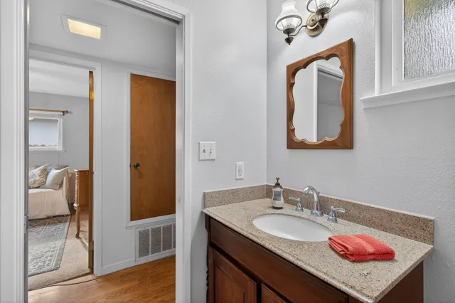 a bedroom with a bed and a dresser with mirror