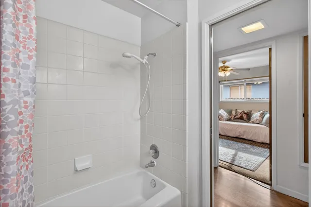 a bathroom with a glass door shower a sink and a mirror