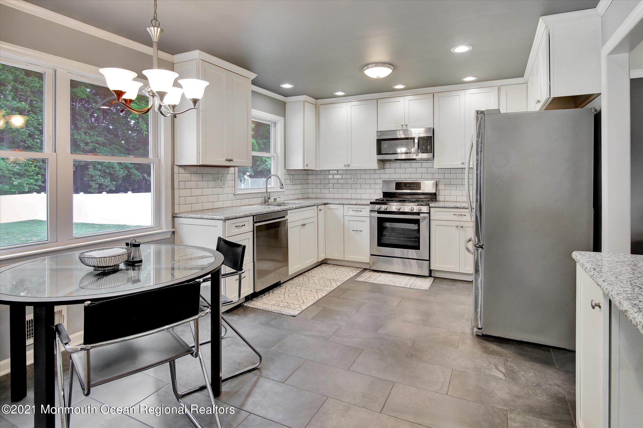 42 Hawthorne Road Red Bank, NJ 07701 - Photo 3 of 20 a kitchen with kitchen island granite countertop stainless steel appliances a sink stove and refrigerator