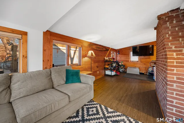 a bedroom with a bed and a flat tv screen