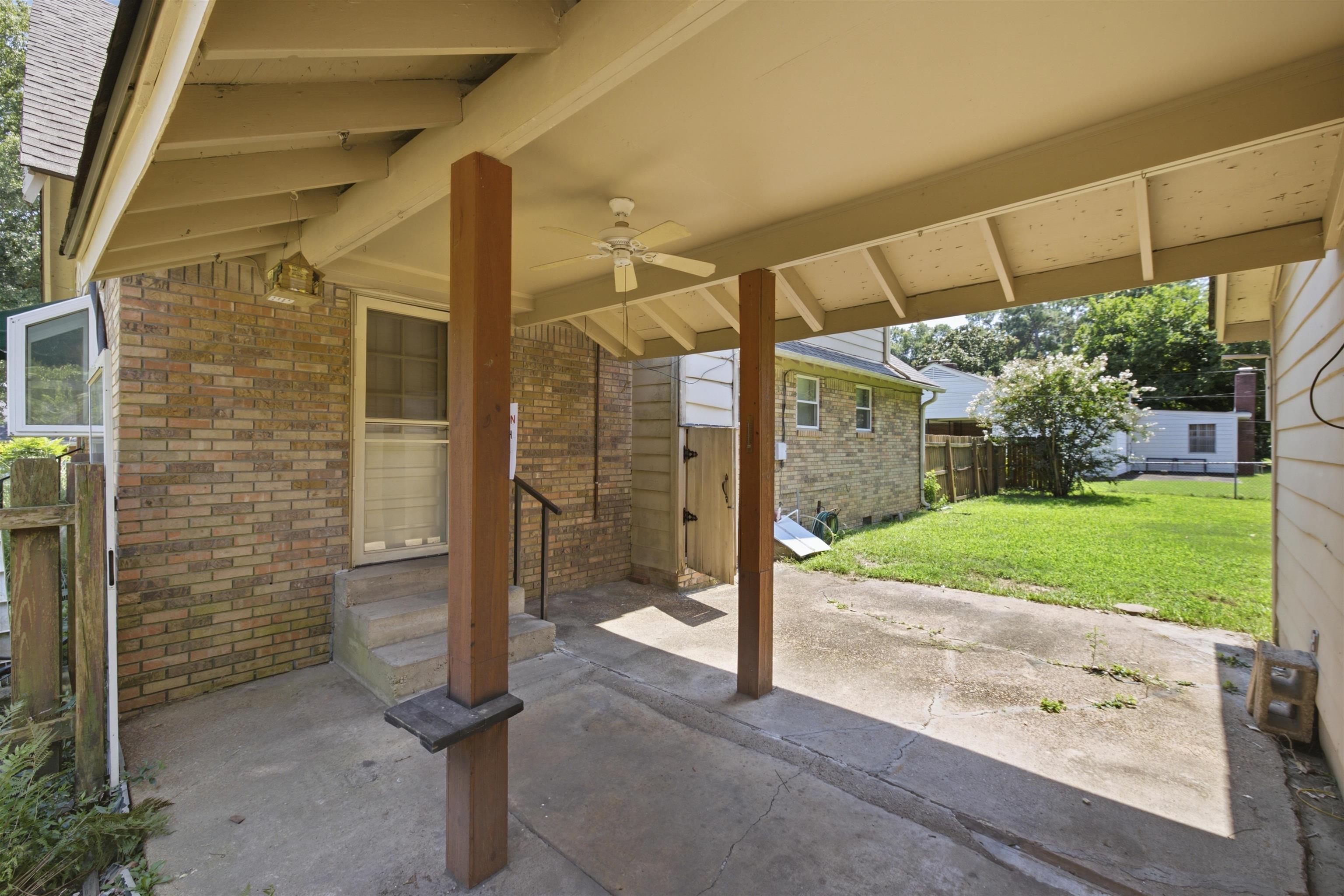 3007 Ruskin Road Bartlett, TN 38134 - Photo 4 of 37 Covered concrete carport featuring a ceiling fan, direct entry to the property, and a brick exterior