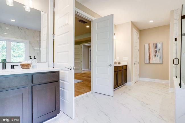 1829 Griffith Road Falls Church, VA 22043 - Photo 19 of 34 a bathroom with a double vanity sink a mirror and a bathtub