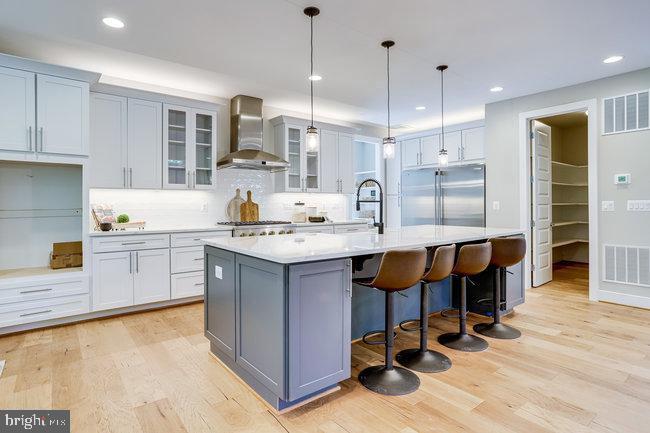 1829 Griffith Road Falls Church, VA 22043 - Photo 3 of 34 a kitchen with kitchen island granite countertop a sink cabinets and wooden floor