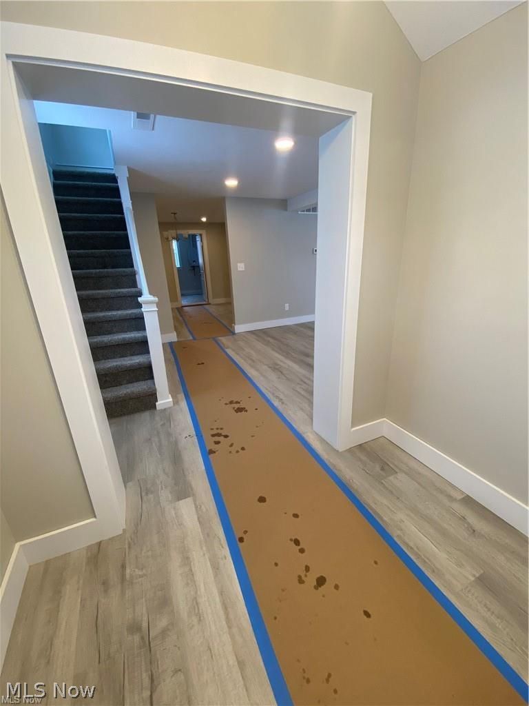 2803 State Road Vermilion, OH 44089 - Photo 8 of 28 Foyer featuring brand new light wood finished floors, stairway, and lofted ceiling.