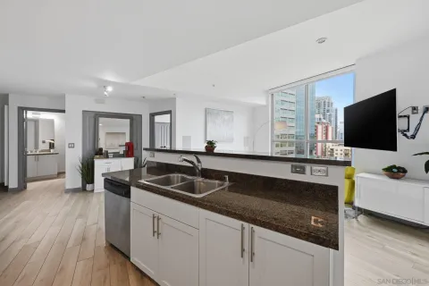 a kitchen with a sink and wooden floor