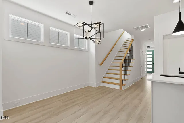 a view of entryway and hall with wooden floor