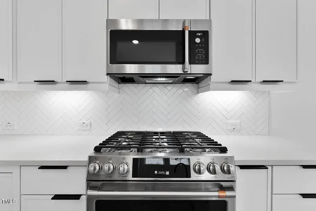 a stove top oven sitting inside of a kitchen