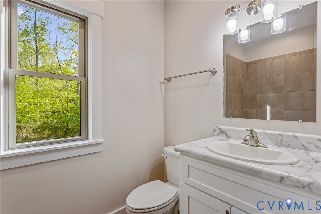 2516 Miry Run Road Sutherland, VA 23885 - Photo 16 of 45 a bathroom with a sink a toilet and a mirror