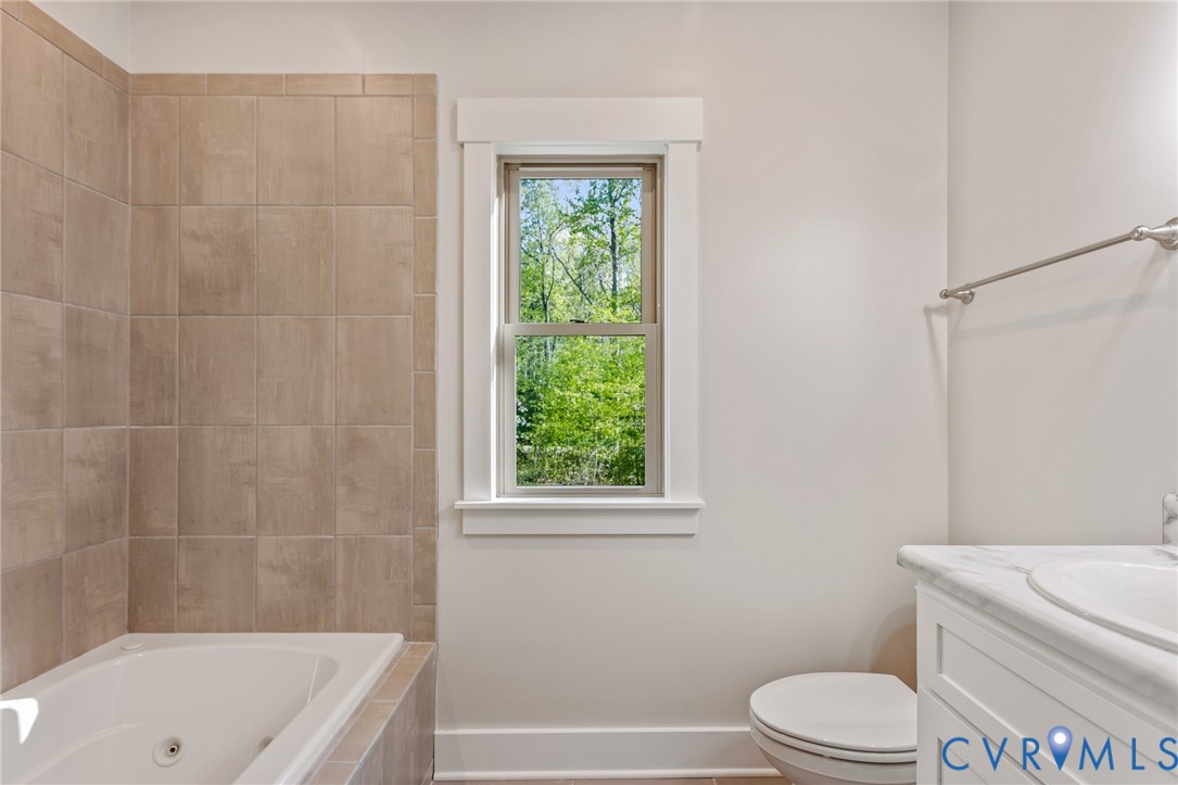 2516 Miry Run Road Sutherland, VA 23885 - Photo 17 of 45 a bathroom with a toilet a sink and a bathtub