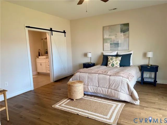 an empty room with a window and a ceiling fan