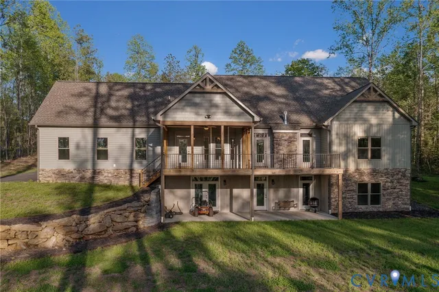 a view of a big house with a big yard and large trees