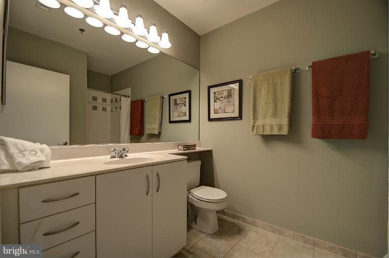 1300 N Street Northwest, Unit 812 Washington, DC 20005 - Photo 2 of 30 a bathroom with a toilet sink and mirror