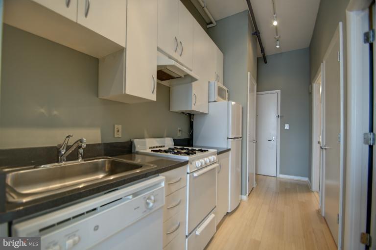 1300 N Street Northwest, Unit 812 Washington, DC 20005 - Photo 23 of 30 a kitchen that has a sink and a stove