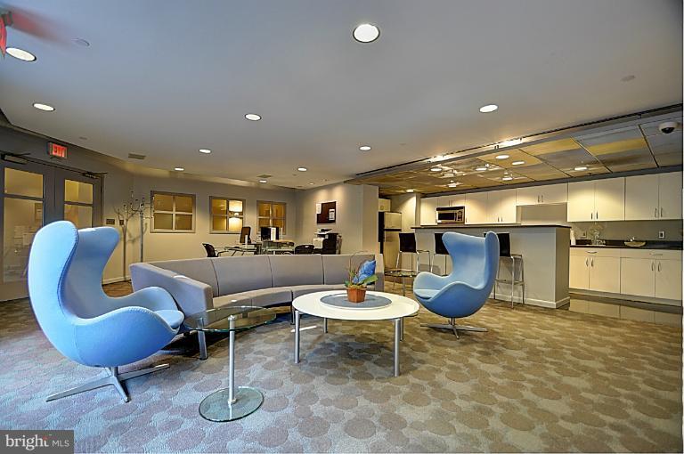 1300 N Street Northwest, Unit 812 Washington, DC 20005 - Photo 28 of 30 a living room with furniture a table and kitchen view