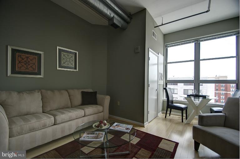 1300 N Street Northwest, Unit 812 Washington, DC 20005 - Photo 4 of 30 a living room with furniture and a large window