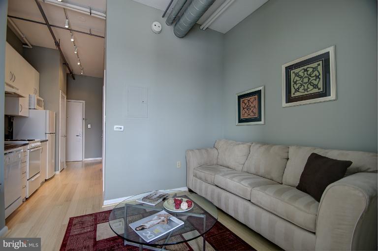 1300 N Street Northwest, Unit 812 Washington, DC 20005 - Photo 5 of 30 a living room with furniture and a flat screen tv