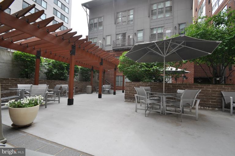 1300 N Street Northwest, Unit 812 Washington, DC 20005 - Photo 10 of 30 a view of a patio with chairs and potted plants