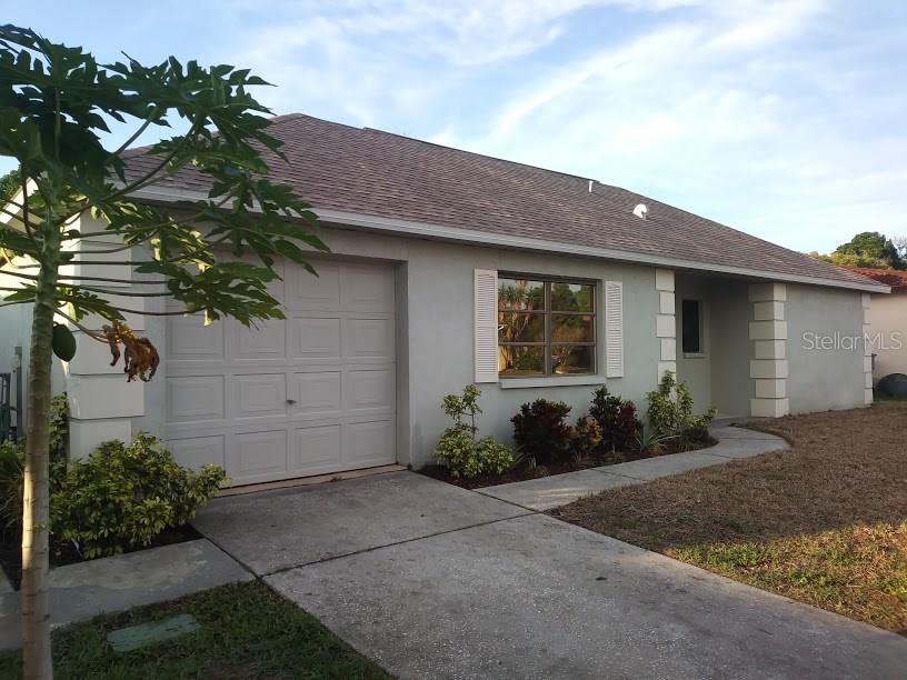 8341 Luray Drive Port Richey, FL 34668 - Photo 1 of 1 a front view of a house with garden