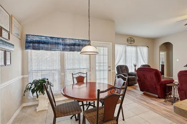 a dining room with furniture and window