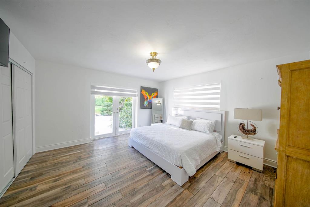 241 Southwest 129th Avenue Miami, FL 33184 - Photo 17 of 27 a bedroom with a bed and wooden floor