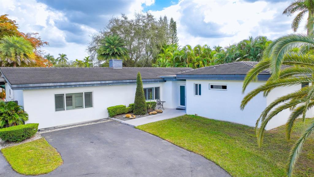 241 Southwest 129th Avenue Miami, FL 33184 - Photo 2 of 27 a front view of a house with garden