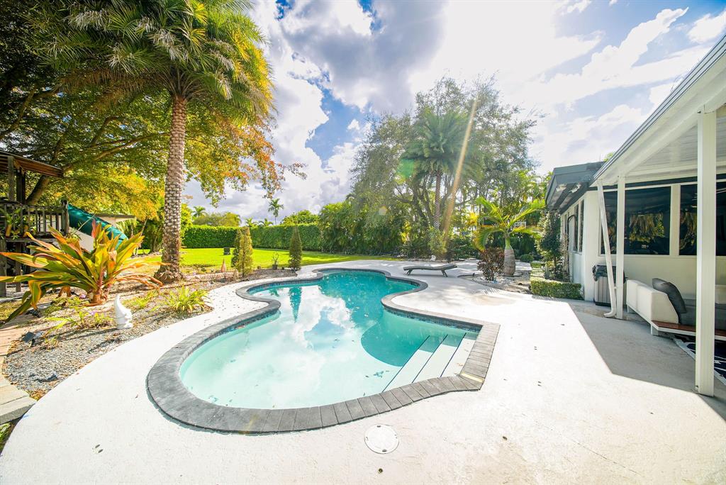 241 Southwest 129th Avenue Miami, FL 33184 - Photo 21 of 27 a view of a swimming pool with a patio