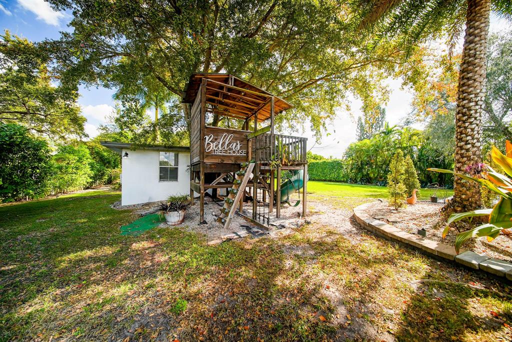 241 Southwest 129th Avenue Miami, FL 33184 - Photo 24 of 27 a view of a yard with furniture and garden