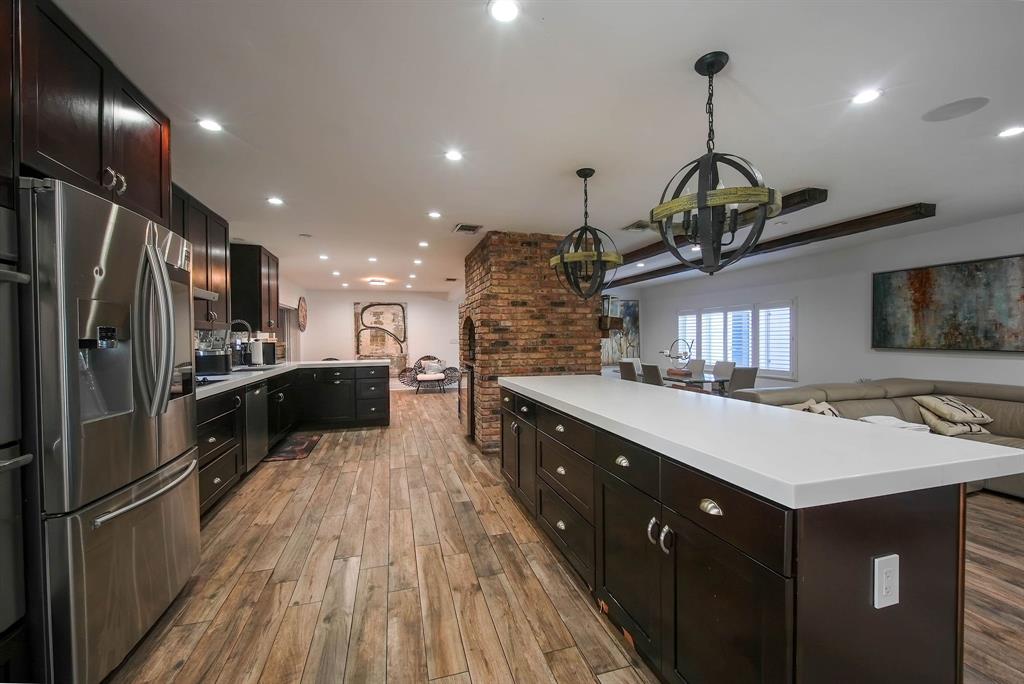 241 Southwest 129th Avenue Miami, FL 33184 - Photo 8 of 27 a kitchen with kitchen island a large counter top space appliances and cabinets