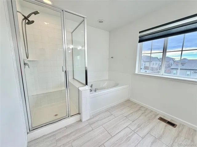 a bathroom with a bathtub and a shower