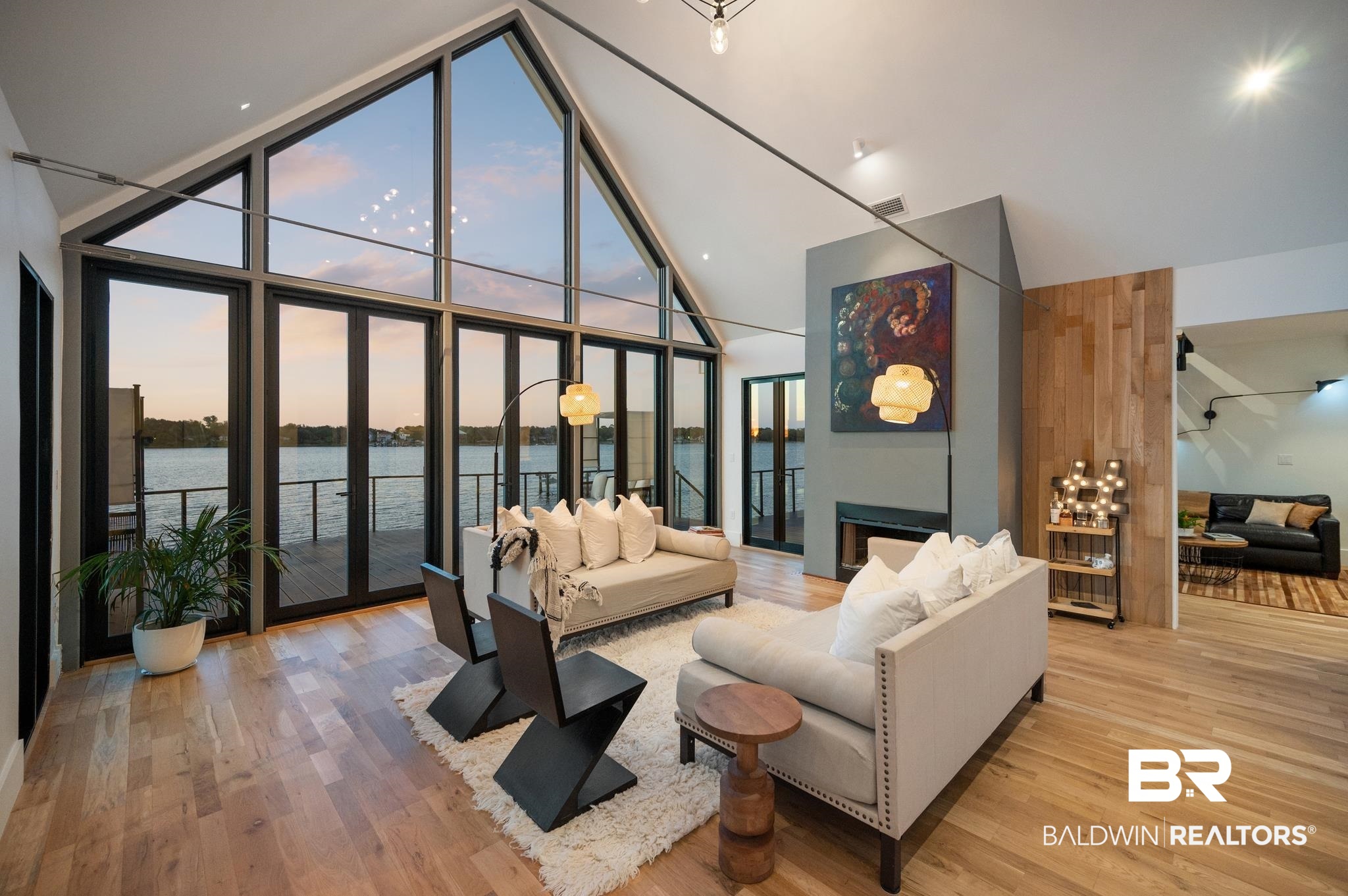 33349 River Road Orange Beach, AL 36561 - Photo 30 of 61 Spacious living area featuring expansive floor-to-ceiling windows, a vaulted ceiling, and wood-finish flooring